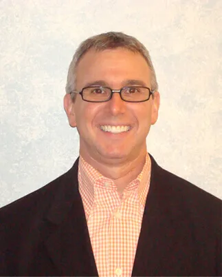 Headshot of Dr. Philip Schnall smiling wearing a sports coat